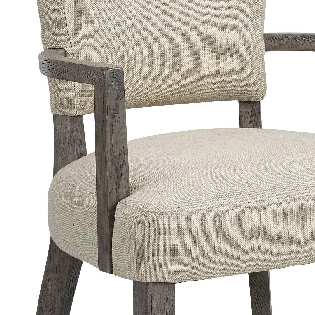 Textured beige upholstered chair with dark wooden arms