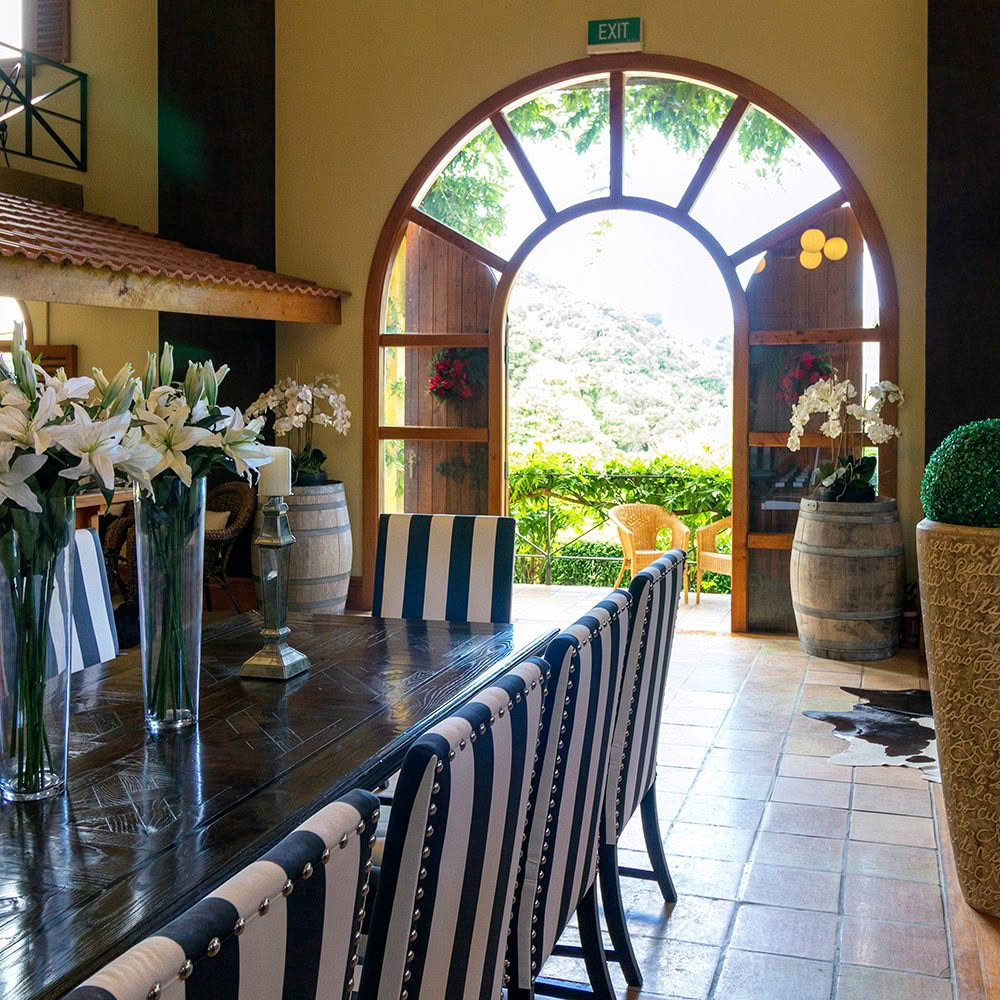 Elegant dining room with arch window overlooking greenery