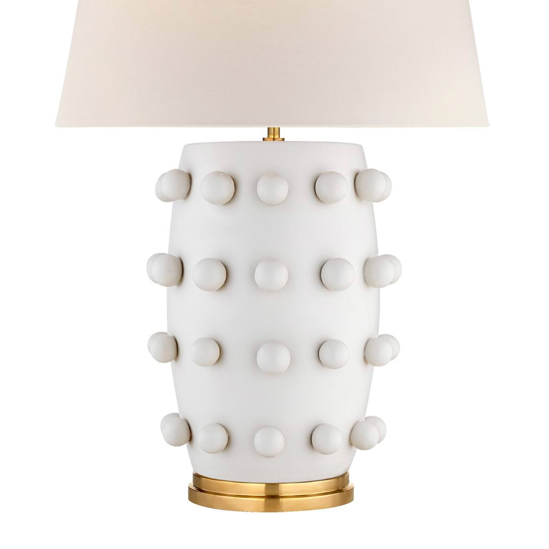 White ceramic lamp with raised dot design and shade