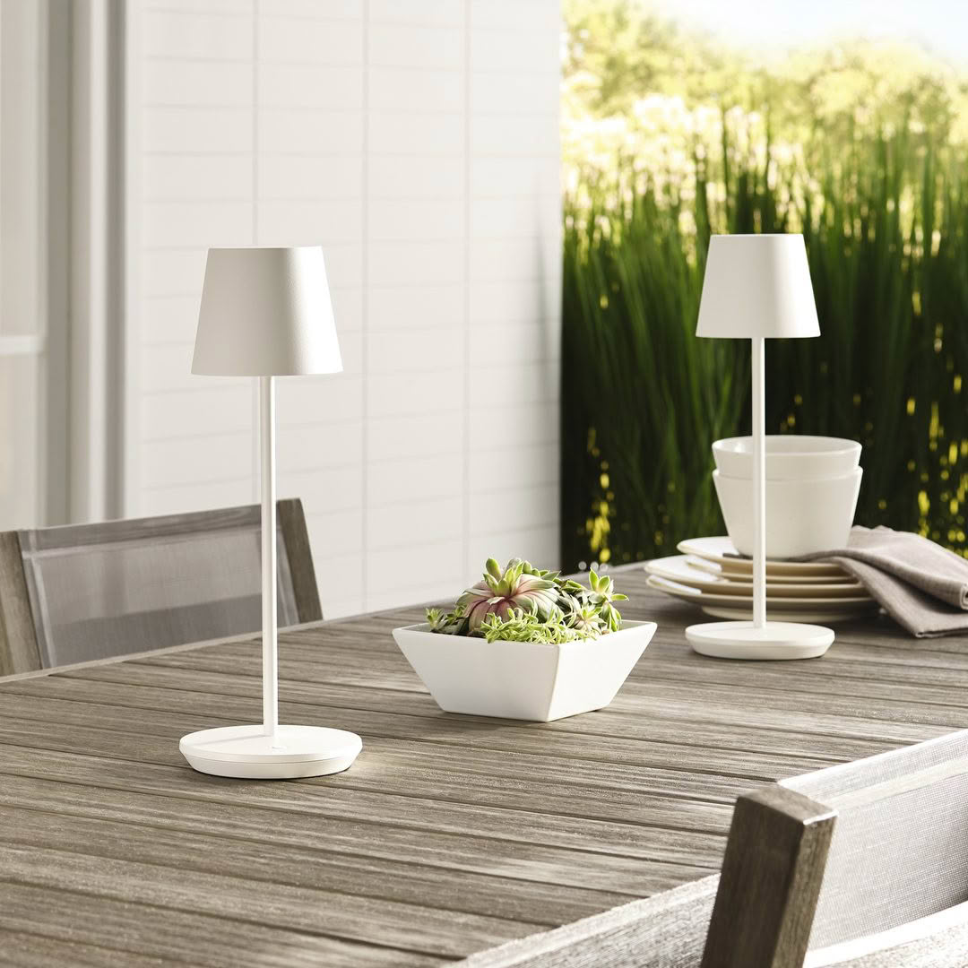 Outdoor table set with lamps and potted plant