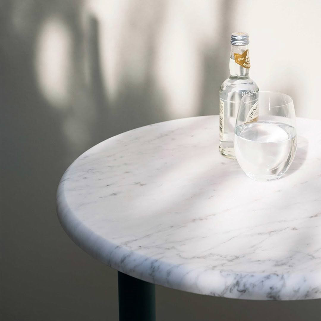Bottle and glass of water on marble table