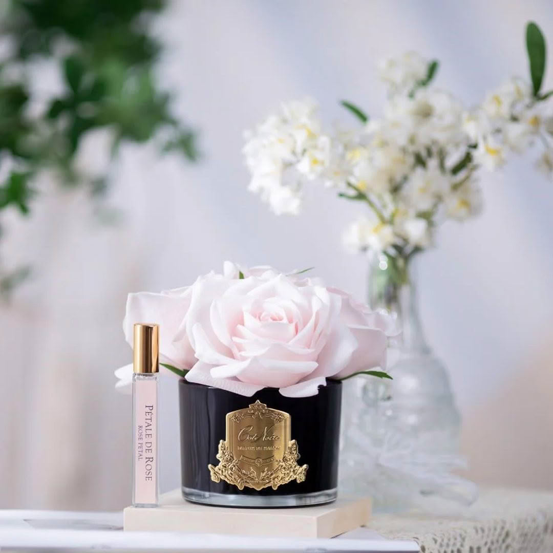 Elegant rose perfume in a decorative black container