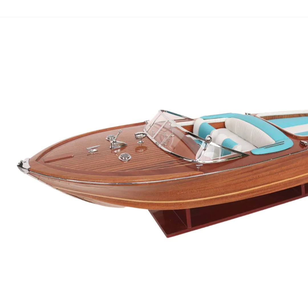 Elegant wooden speedboat with turquoise interior.