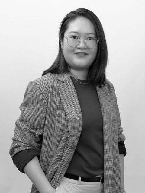 Young woman smiling in black and white portrait