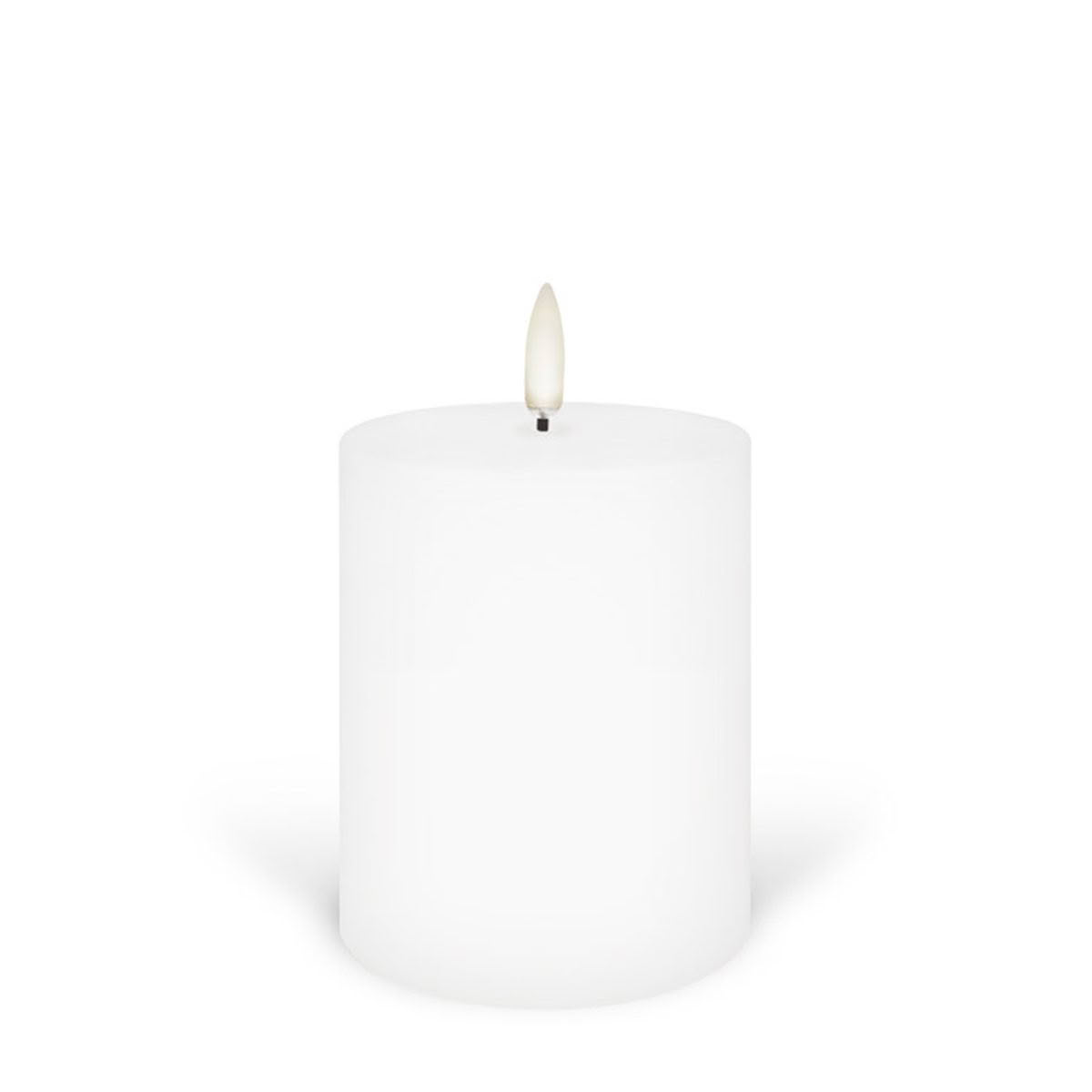 White cylindrical candle on plain background