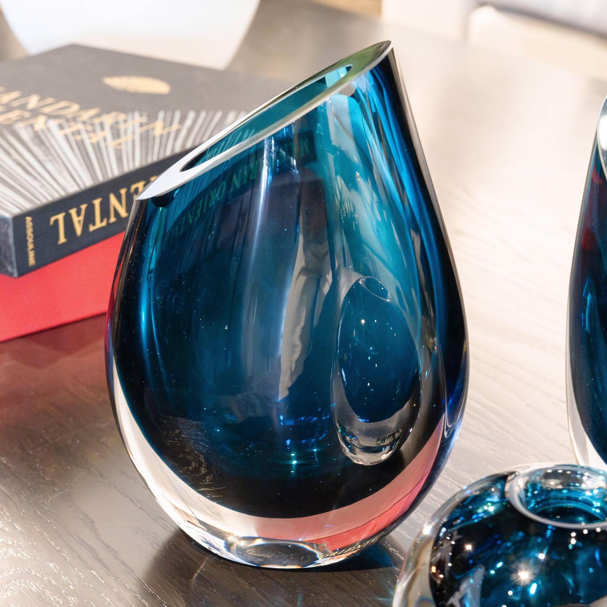 Elegant blue glass vase on wooden table