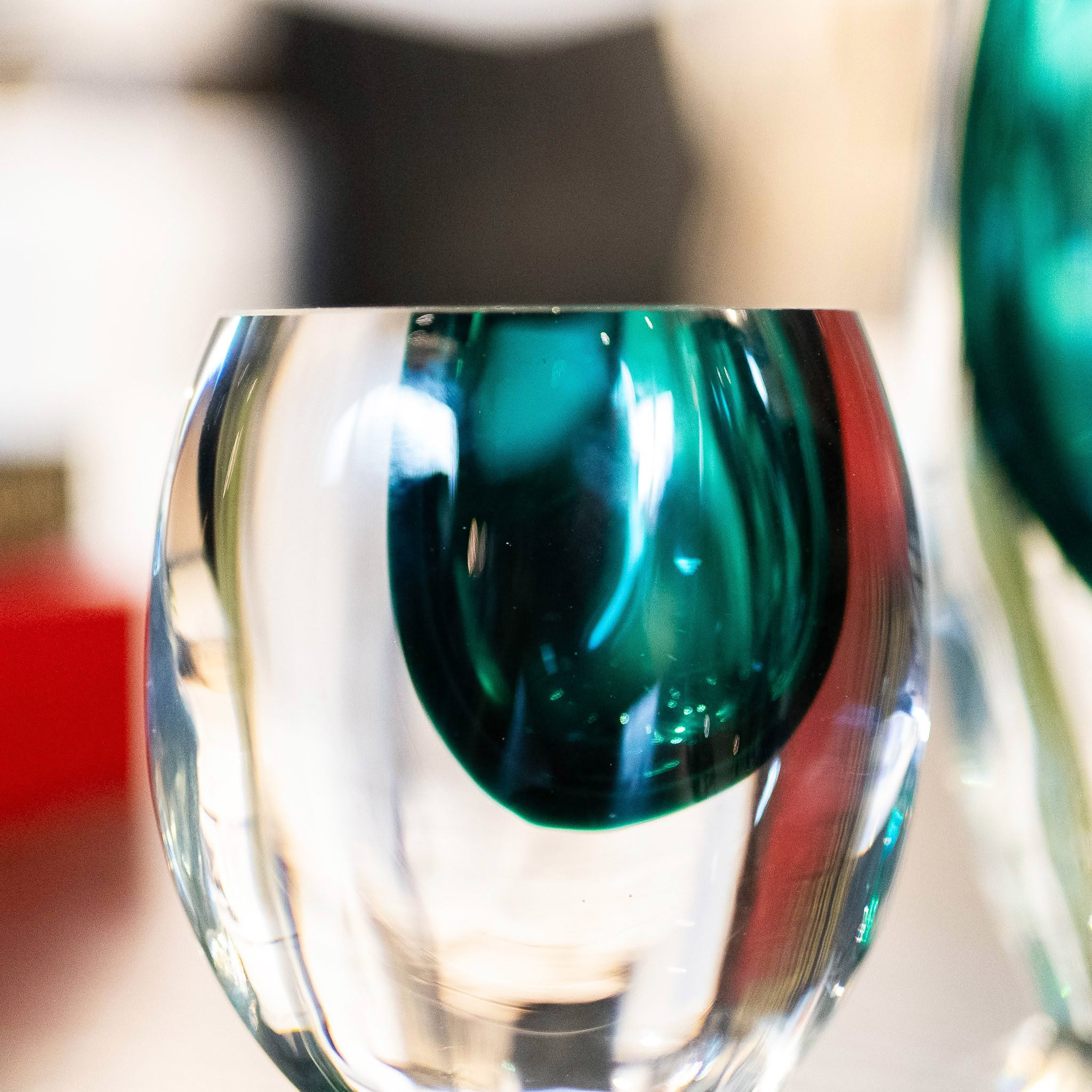 Clear glass vase with distorted green reflections