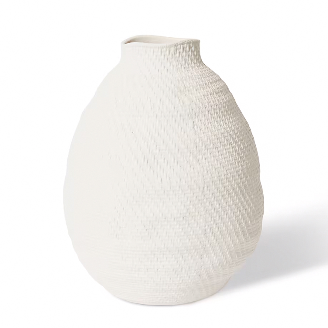 Textured white ceramic vase on white background
