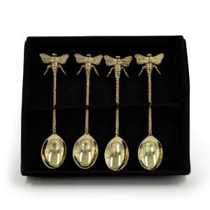 Golden dragonfly spoons with rhinestones on black display