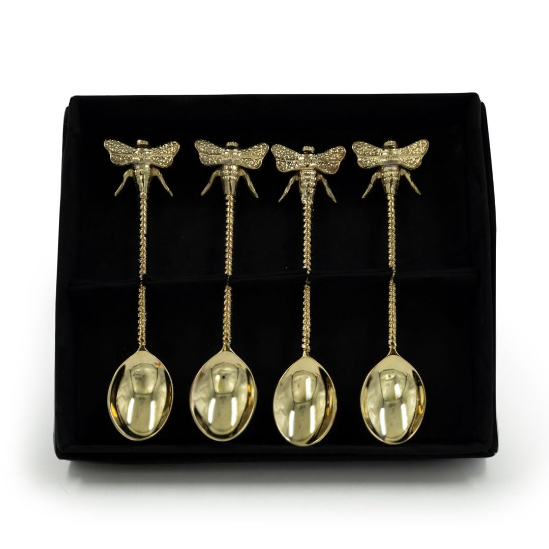 Golden dragonfly spoons with rhinestones on black display