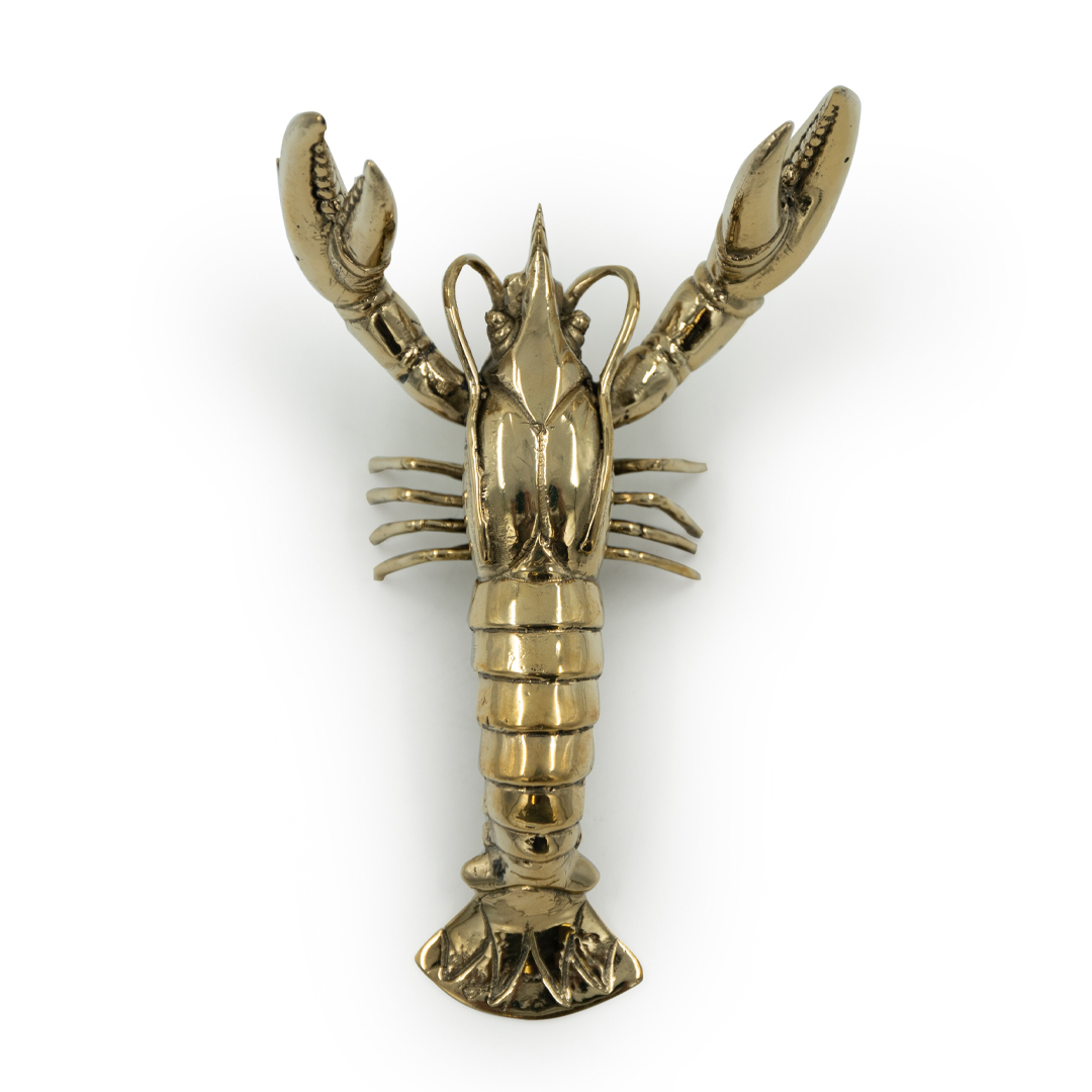 Golden lobster sculpture on white background