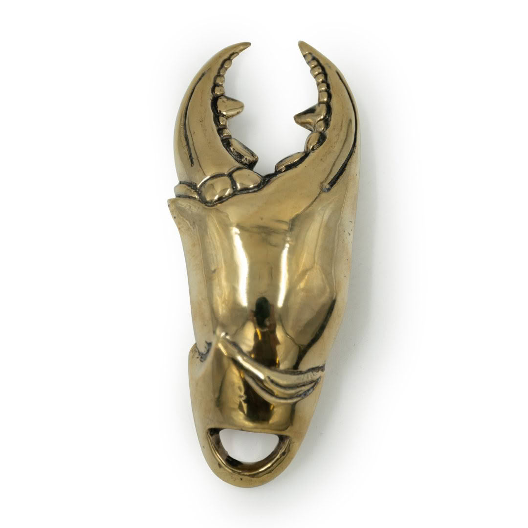 Gold crab claw pendant isolated on white background