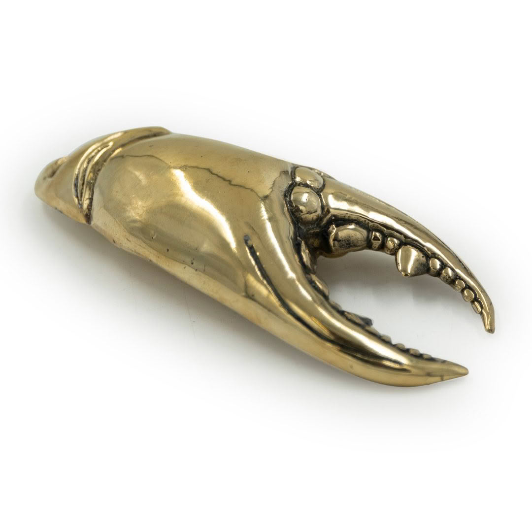 Golden crab claw sculpture isolated on white background