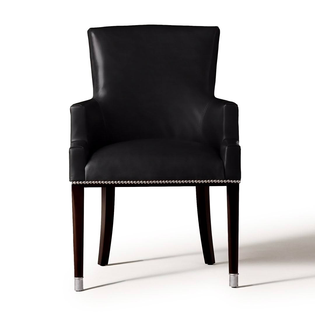 Elegant black leather armchair with silver nailhead details