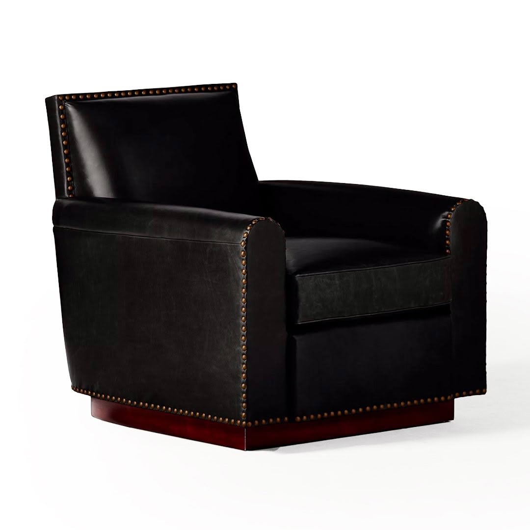 Black leather armchair with brass nailhead trim