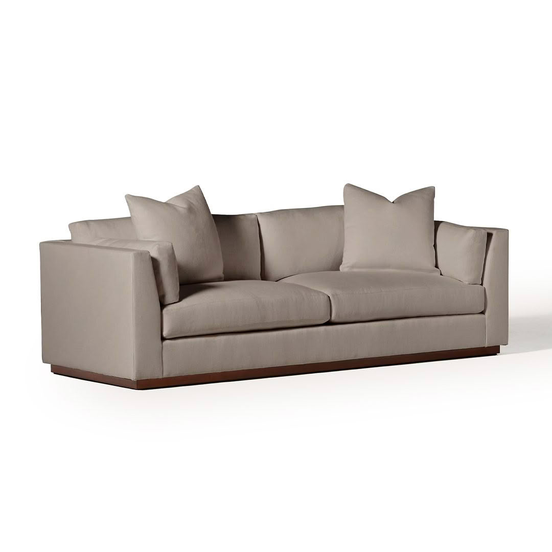 Modern gray sofa with cushions on white background