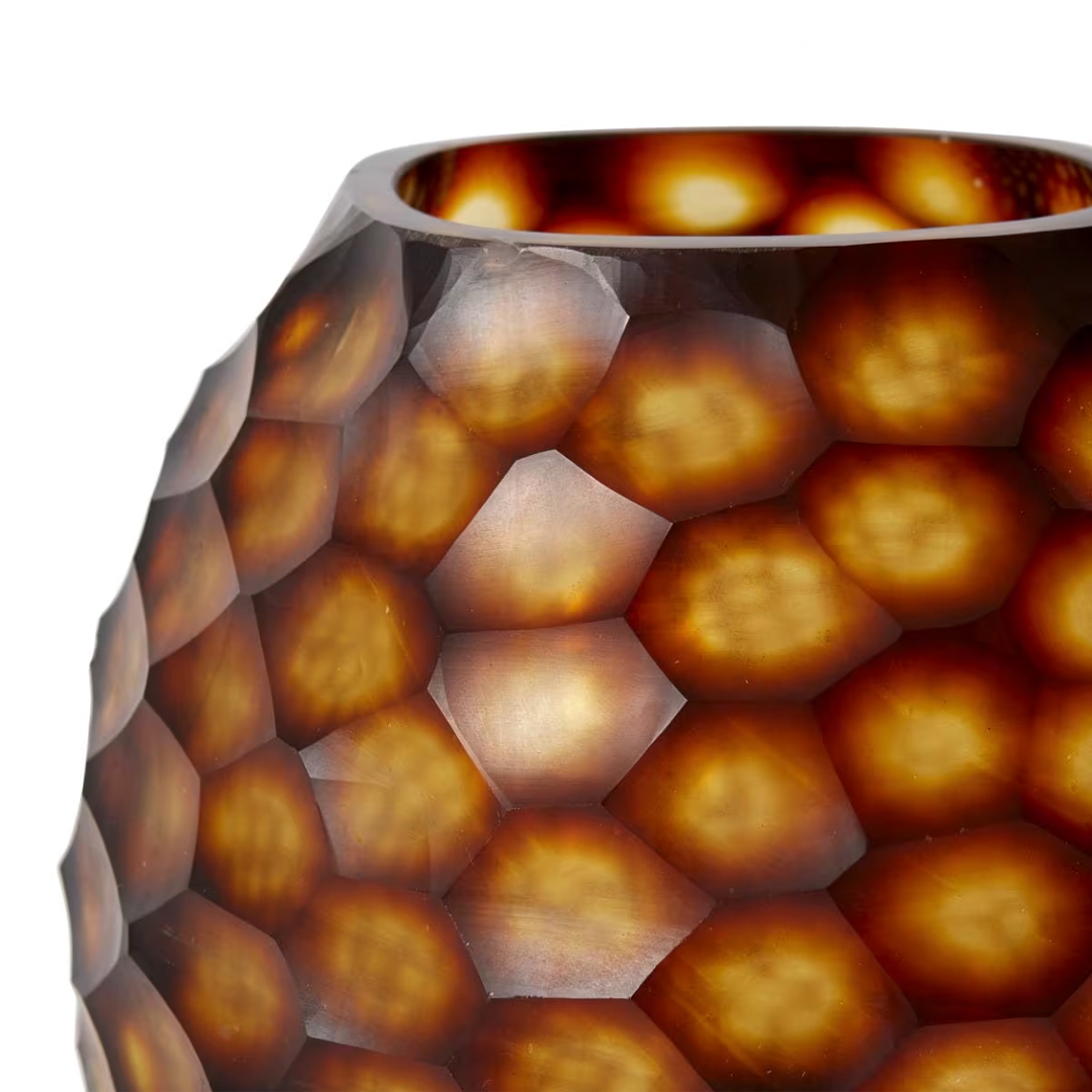Close-up of textured amber-colored glass vase