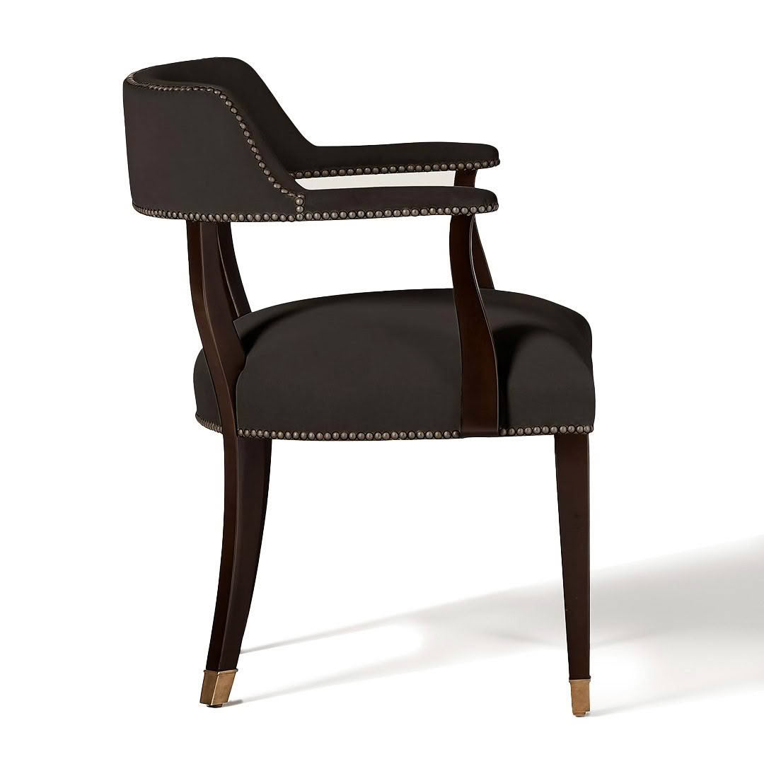 Elegant black armchair with brass accents and nailhead trim