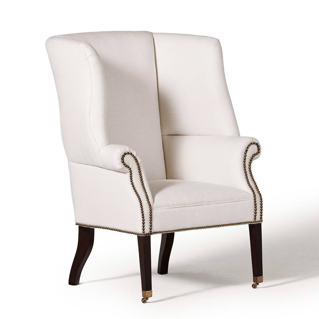 Elegant high-back beige wing chair with dark wooden legs