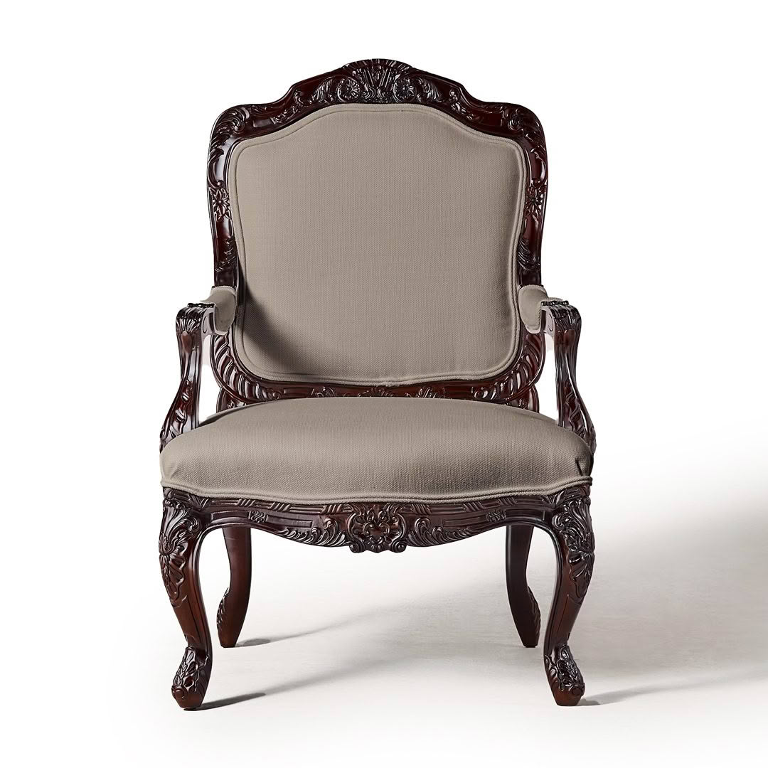 Ornate mahogany armchair with beige upholstery