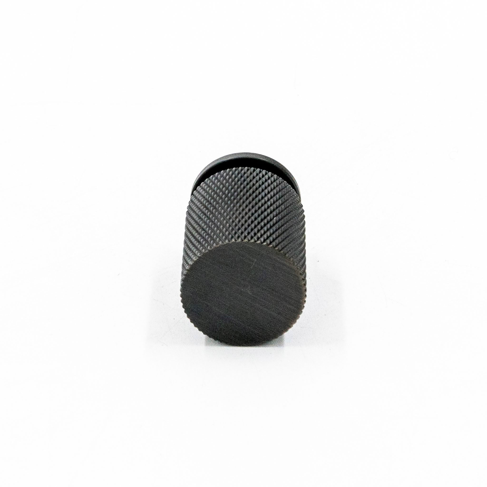 Black textured knob on white background