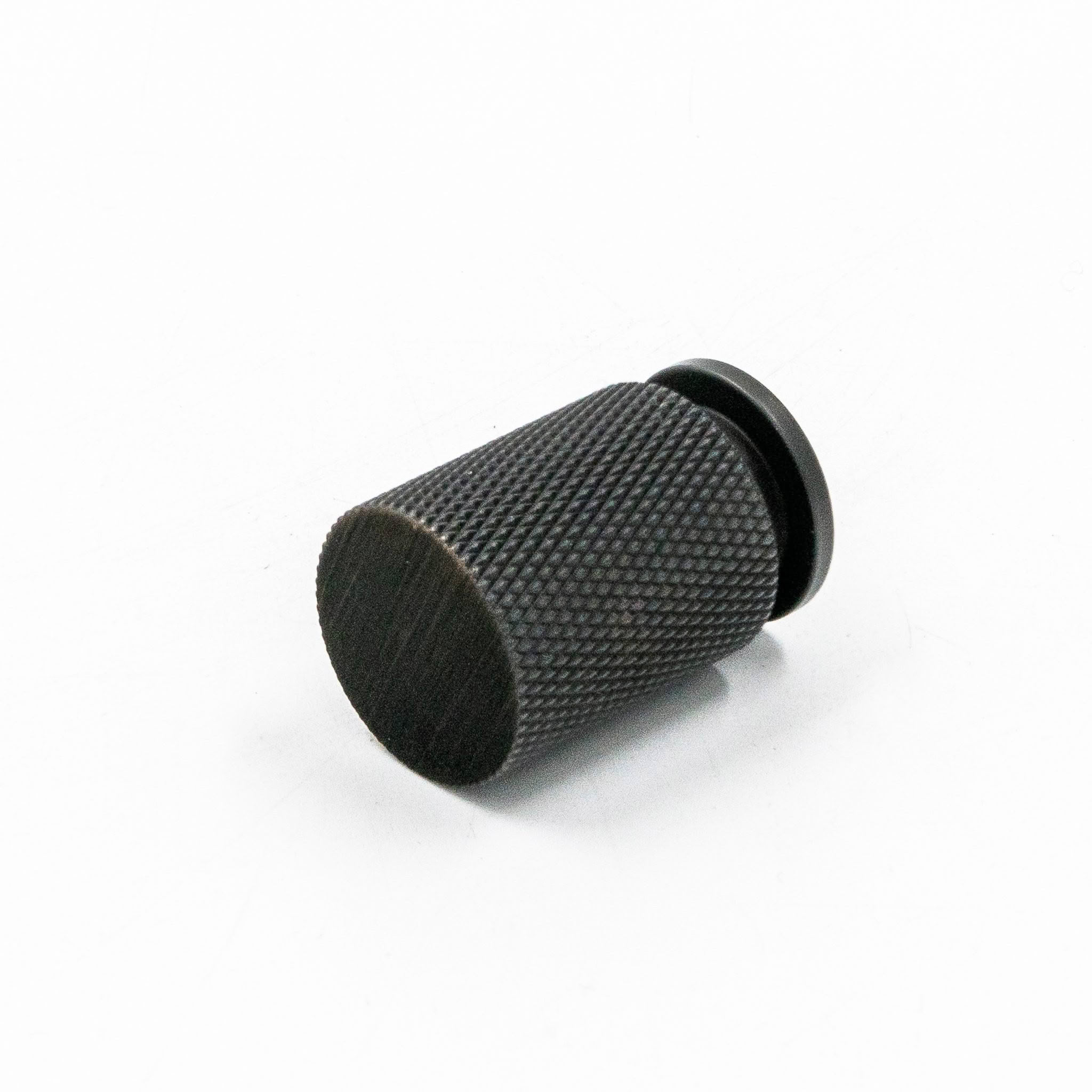 Black textured knob on white background