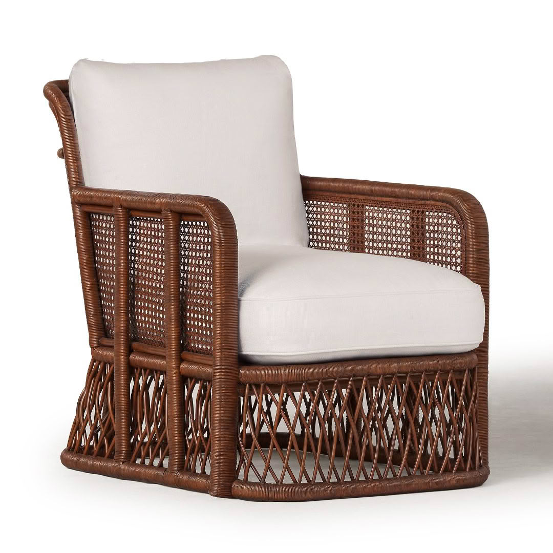 Elegant wicker armchair with white cushion
