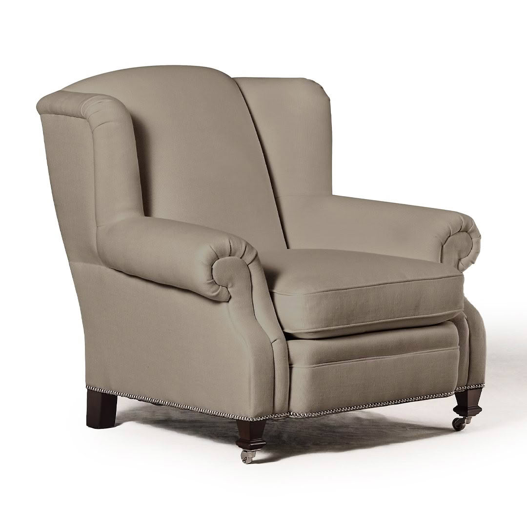 Elegant beige upholstered wingback chair with nailhead trim