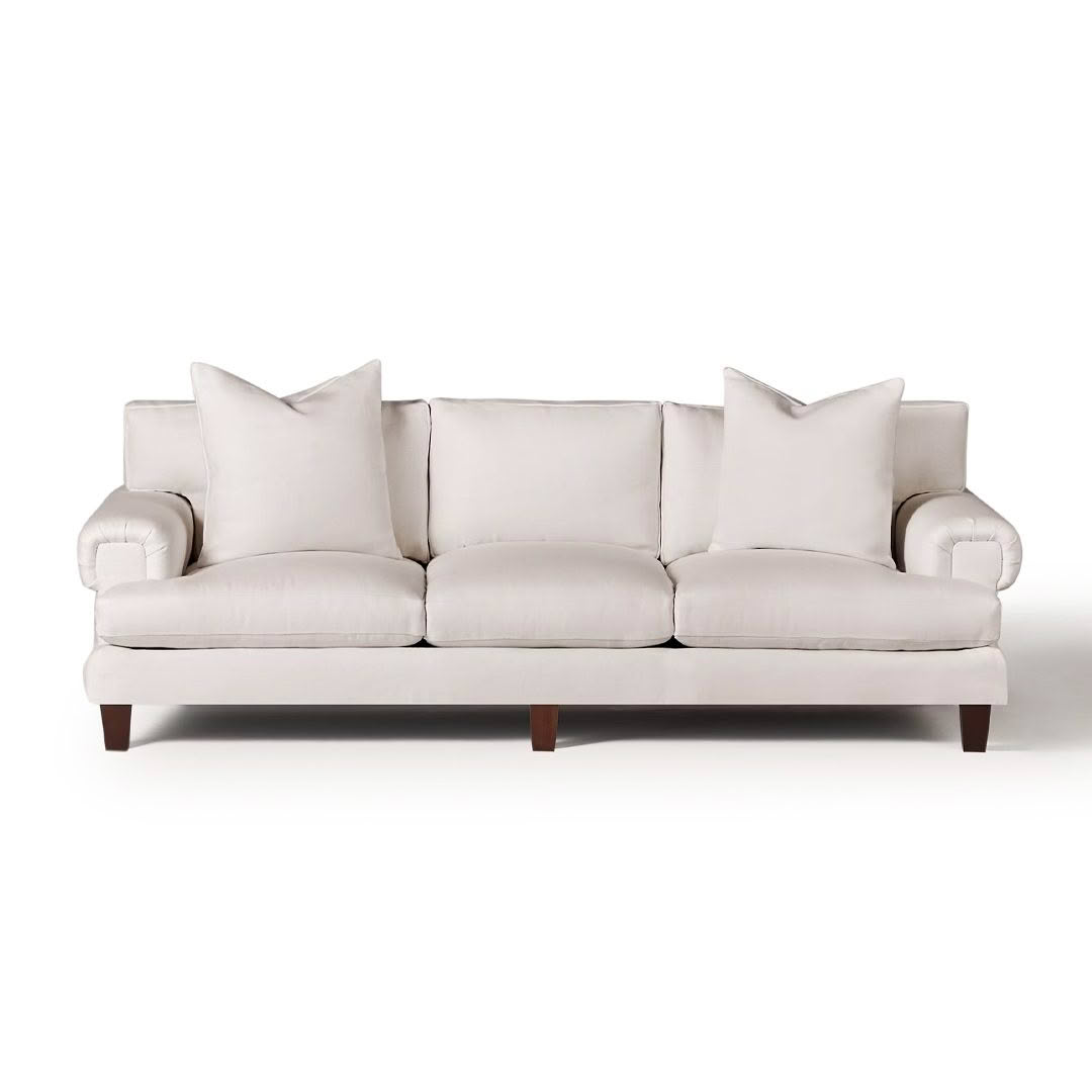 Elegant white fabric sofa with plush cushions