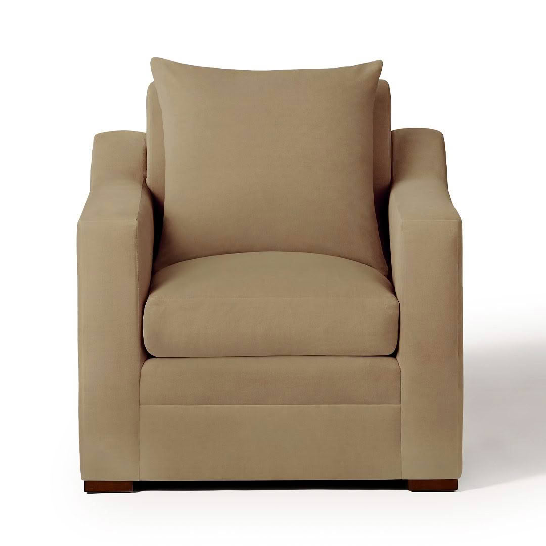 Beige upholstered armchair isolated on white background