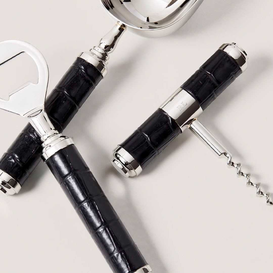 Elegant black and silver wine openers on light background