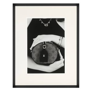 Fashion photo of woman holding designer Louis Vuitton bag