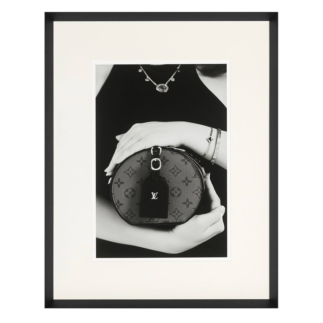 Fashion photo of woman holding designer Louis Vuitton bag