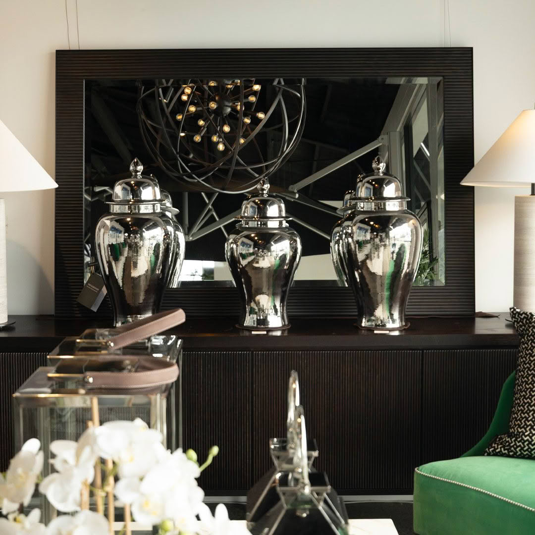 Luxurious silver urns on display at upscale interior store