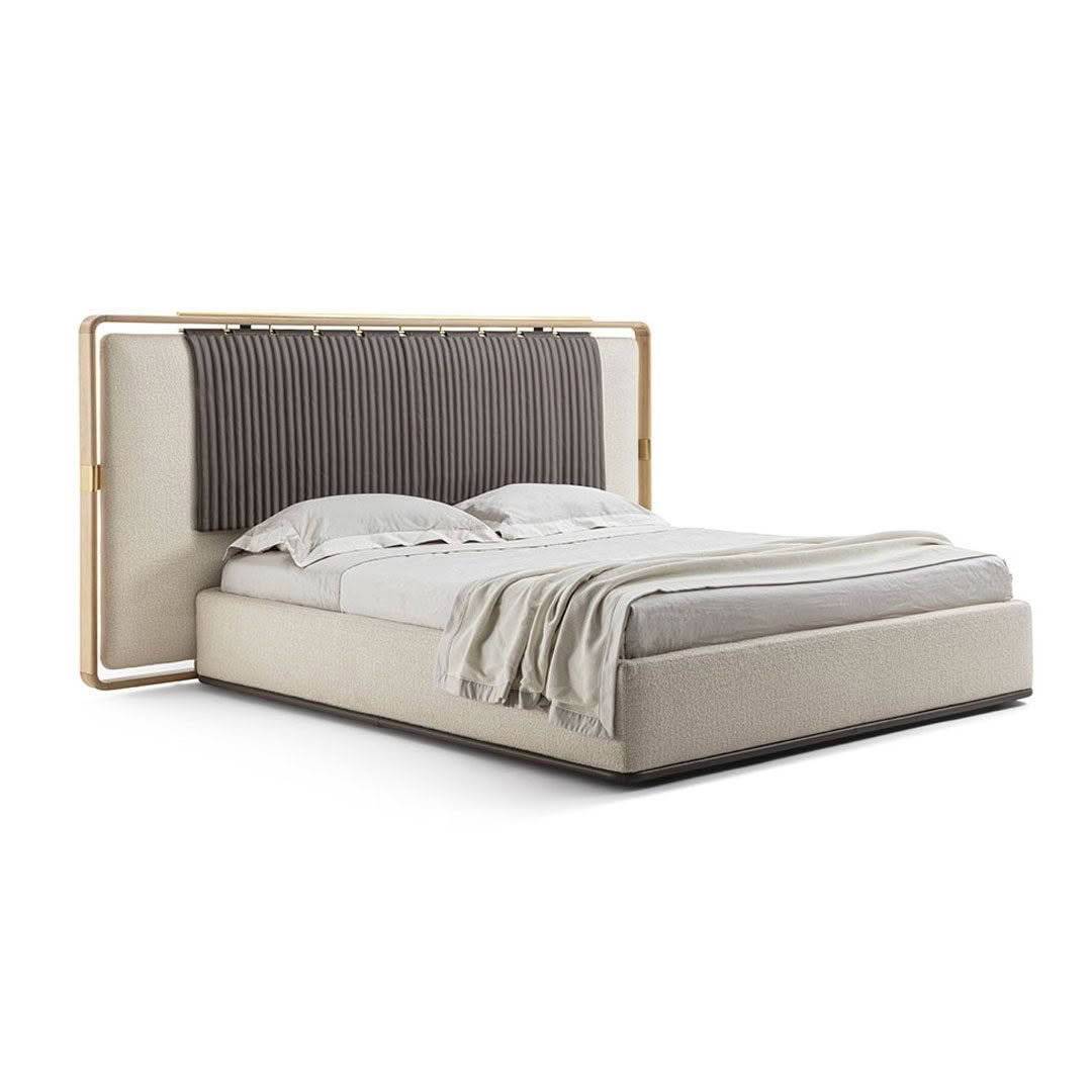 Modern bed with gray bedding and golden frame