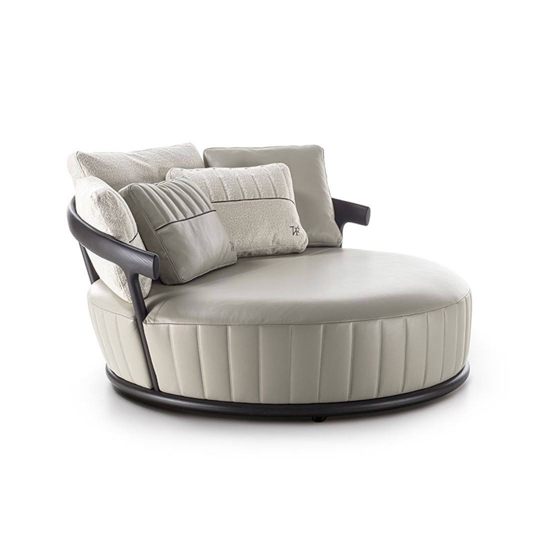 Elegant round green sofa with plush pillows