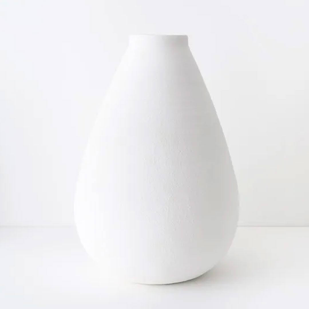 Simple white ceramic vase on a clean background
