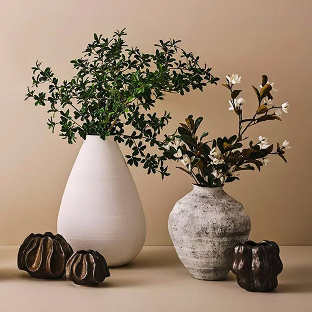 Two vases with plants and decorative seed pods
