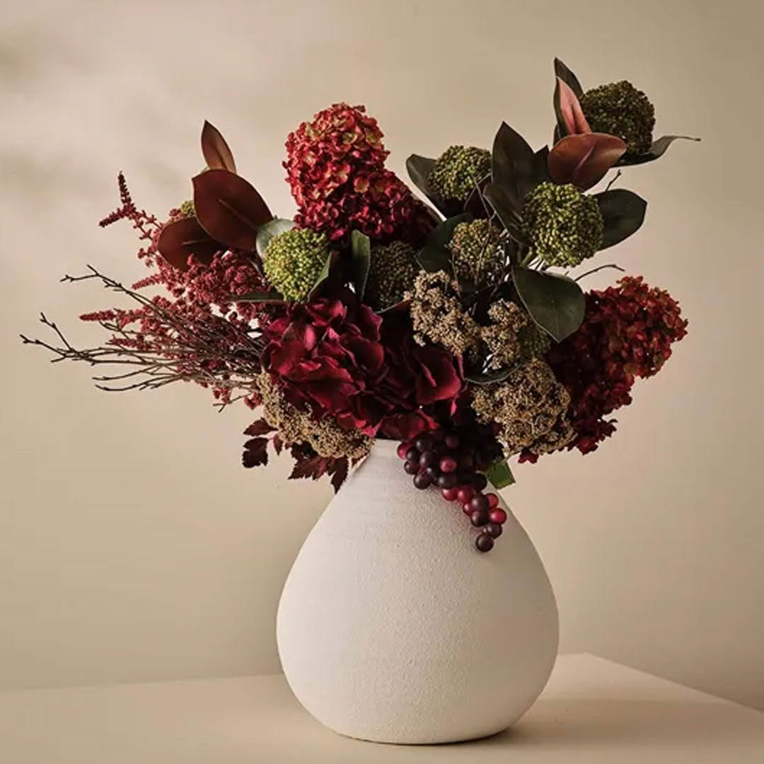 Elegant autumn floral arrangement in white vase