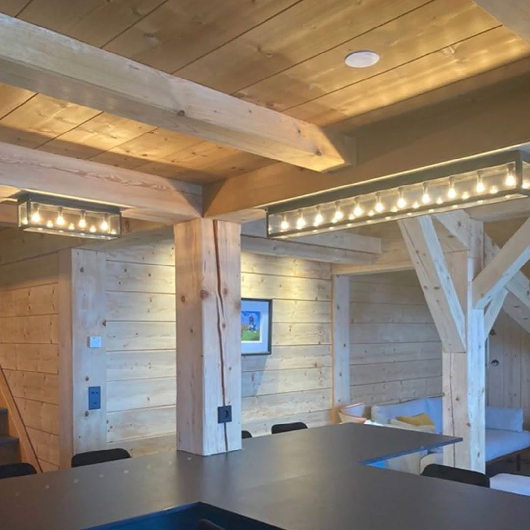 Rustic wooden interior with beams and modern lighting