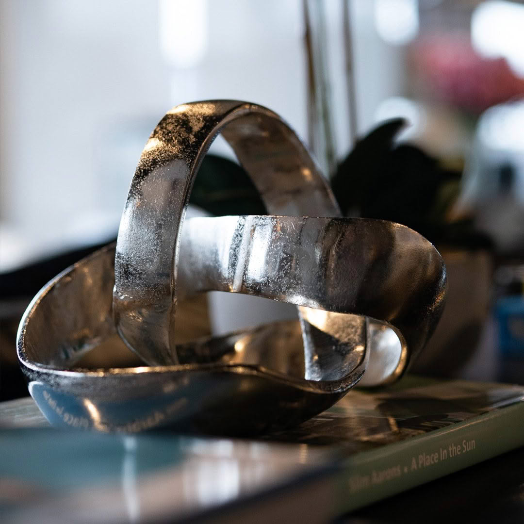 side bendigo square Shiny metallic sculpture on book