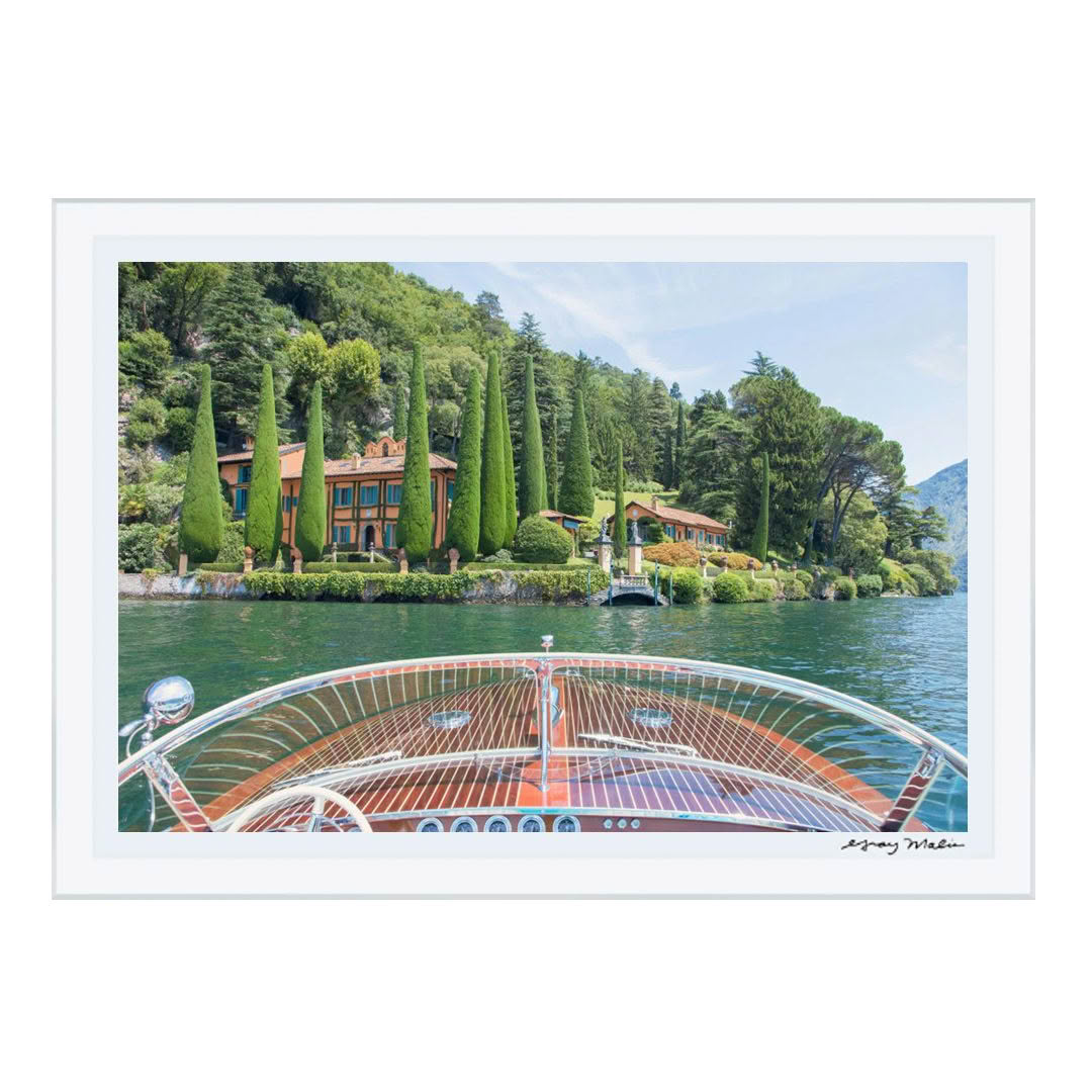 Lush villa and garden viewed from boat on lake