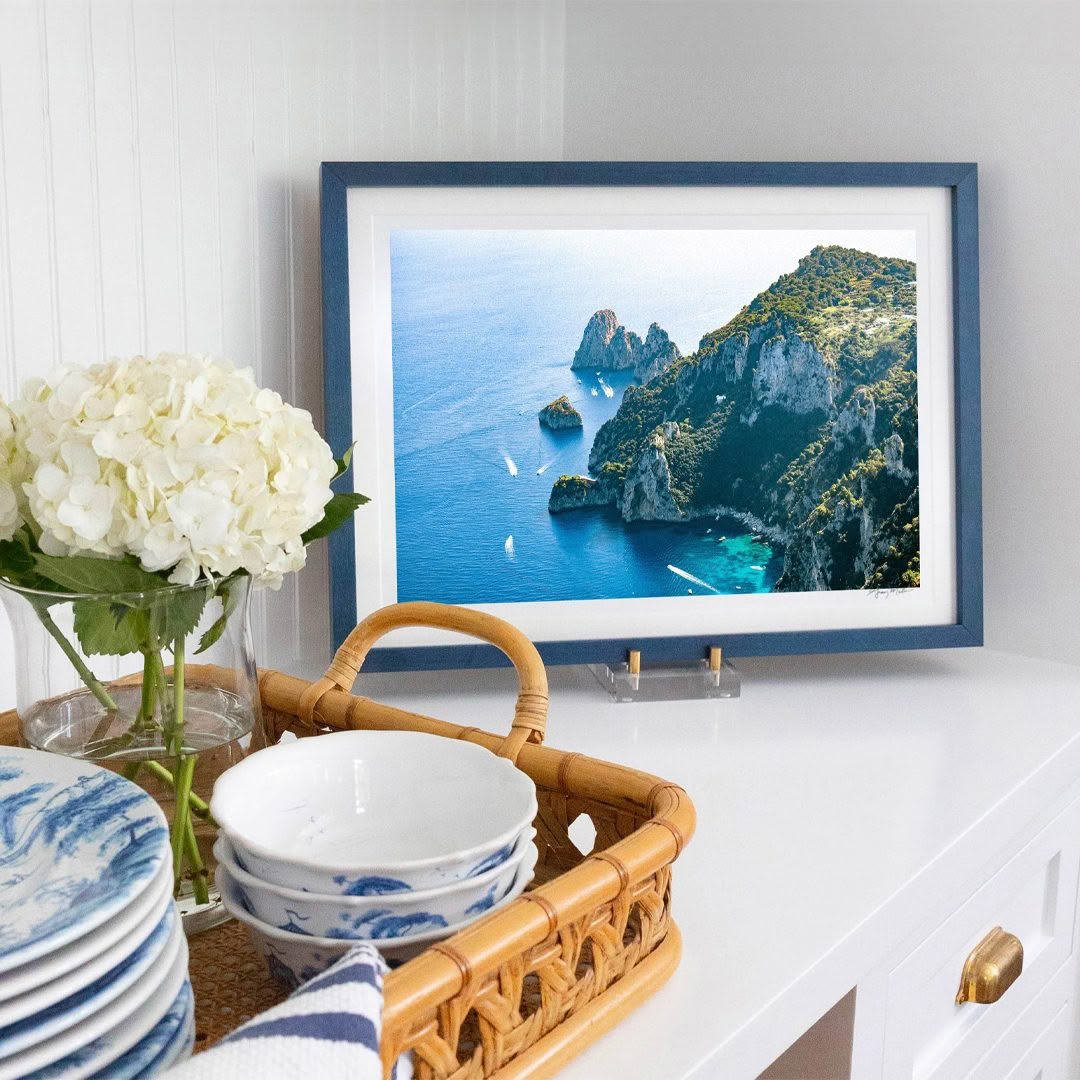 Coastal landscape photo in framed picture on home cabinet