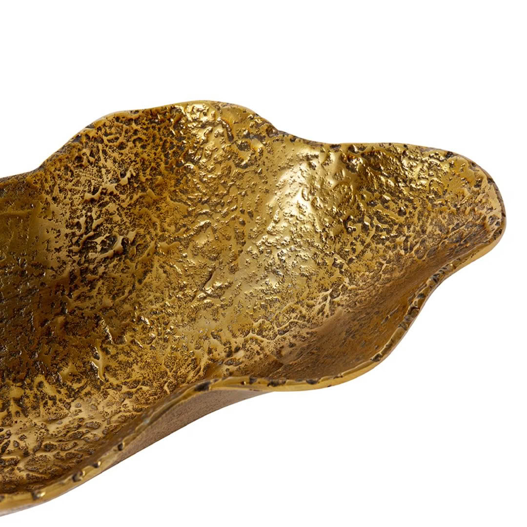 Textured golden metallic object on white background