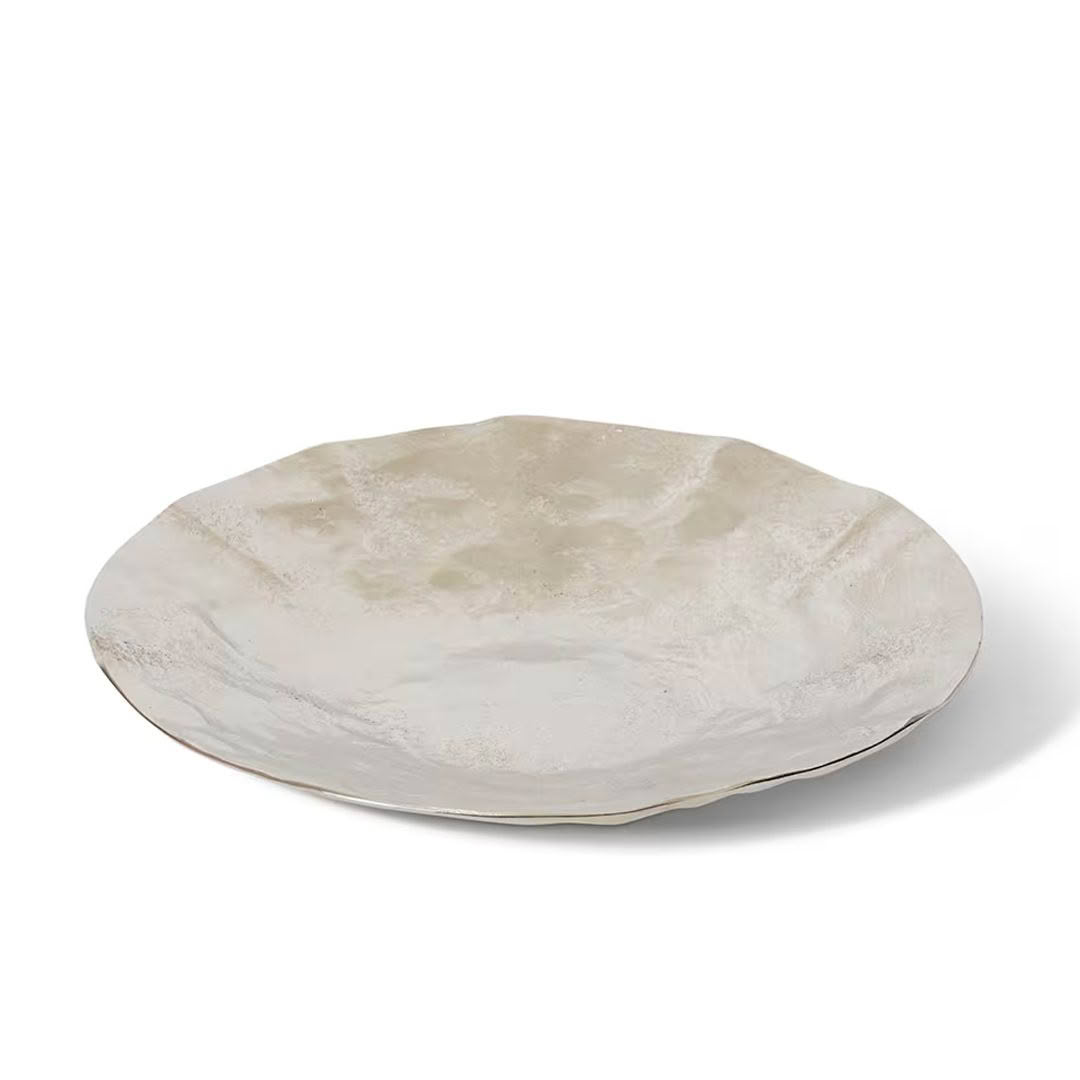 Textured ceramic off-white serving plate on white background