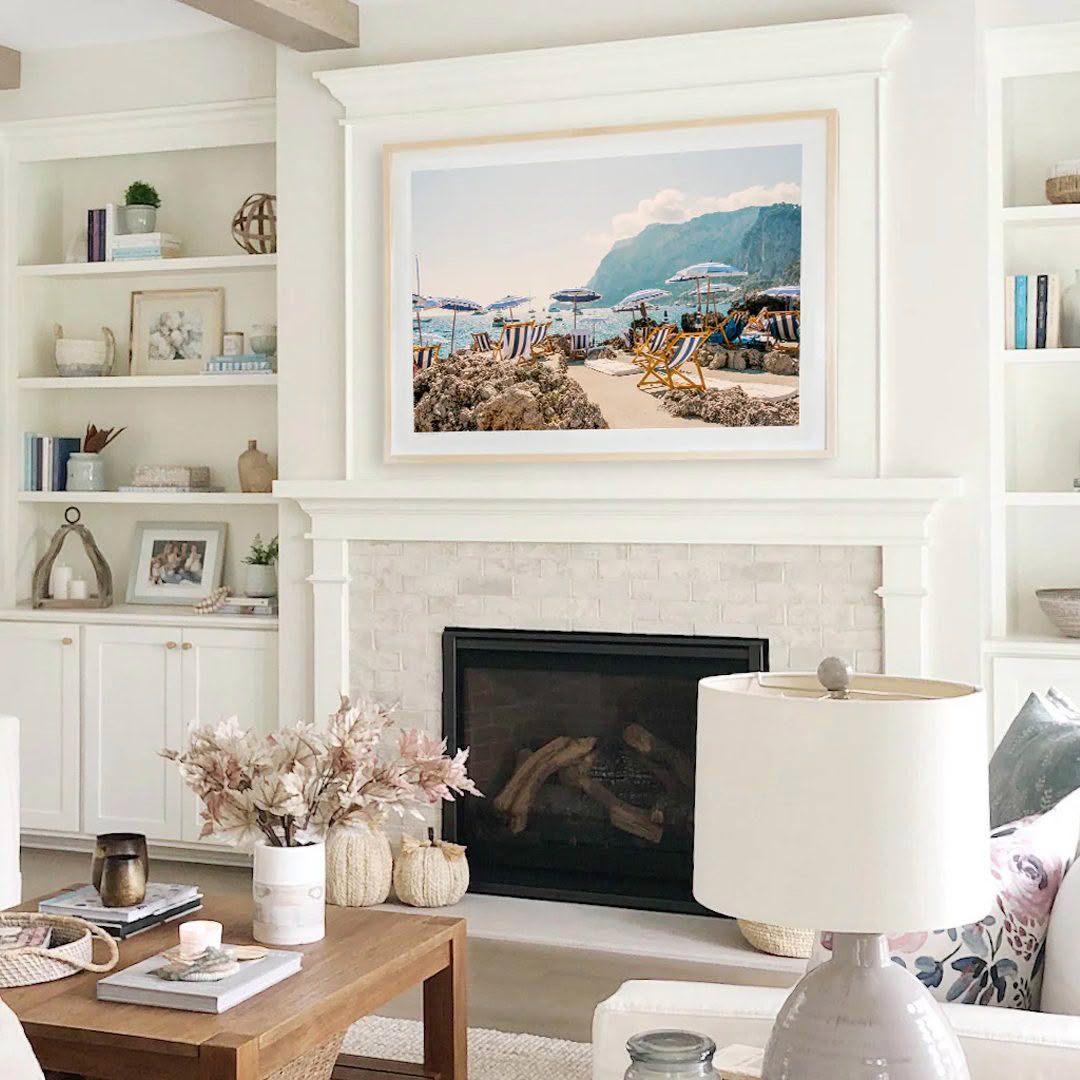 Cozy living room with beach painting over fireplace