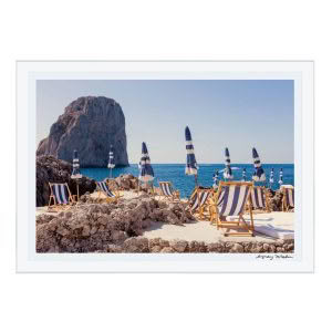 Seaside loungers and umbrellas overlooking rocky cliff