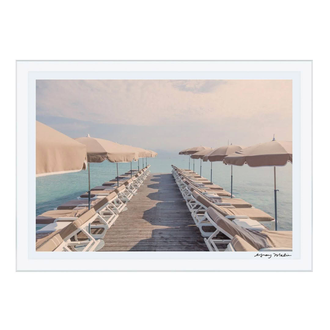 Serene beach pier with umbrellas and lounge chairs