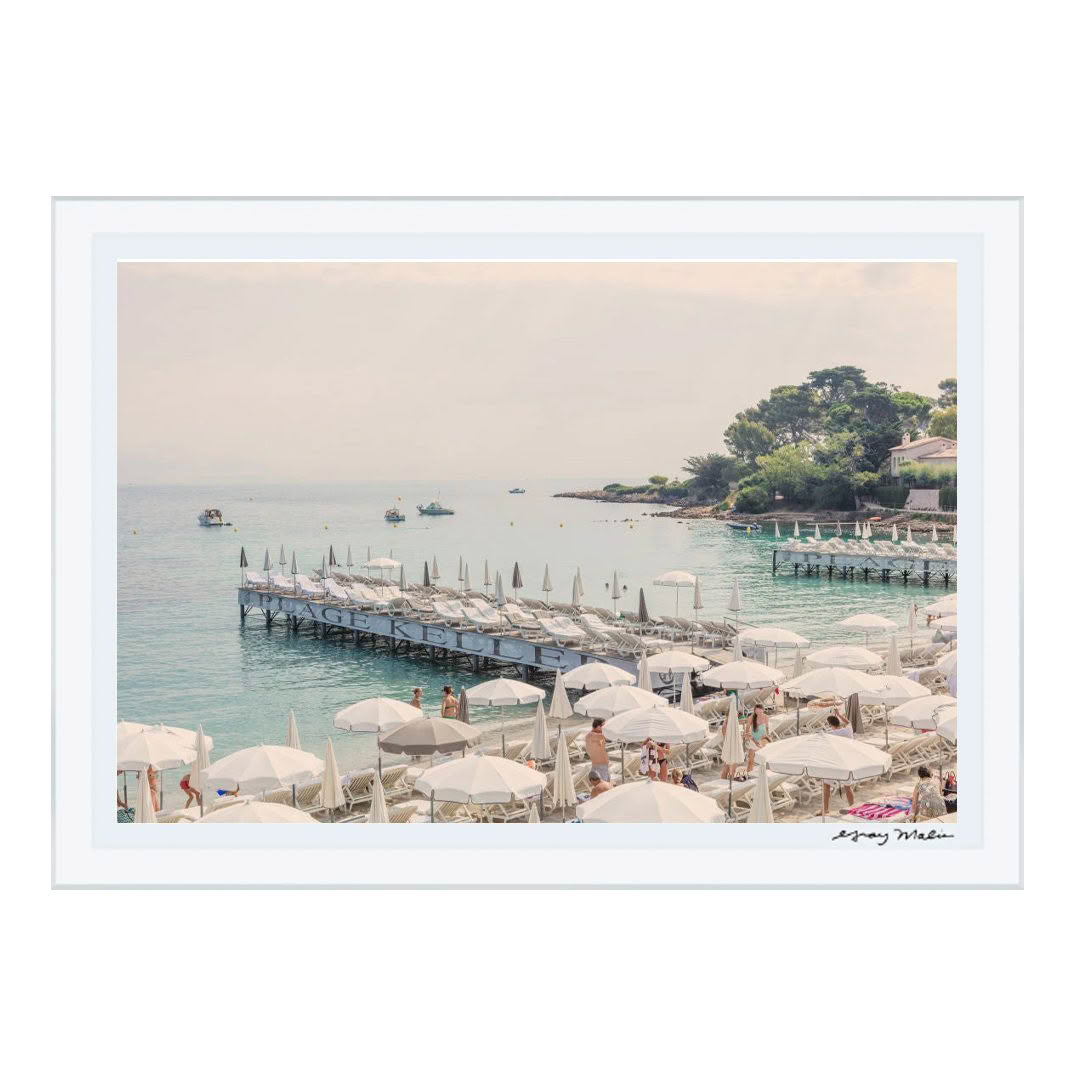 Seaside resort with umbrellas, beach chairs, and pier