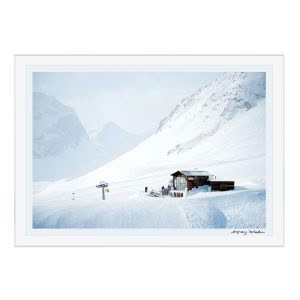 Snow-covered mountain with ski lift and cabin
